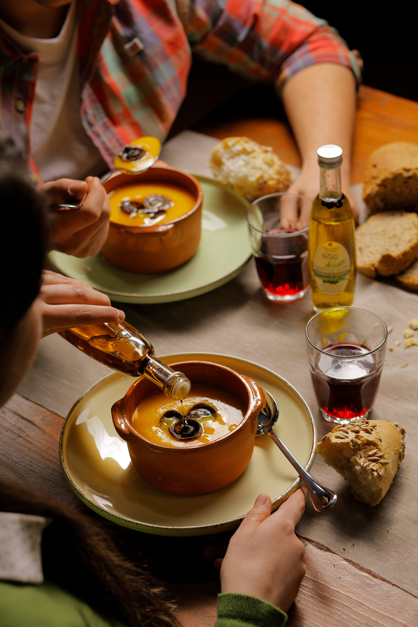 _79a7782 ragazze a tavola che mangiano una zuppa con dei tortelli conditi con un filo d' olio